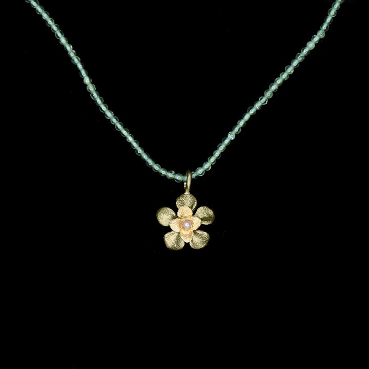 Image of the Michael Michaud Desert Flower Pendant - Peridot on a black background