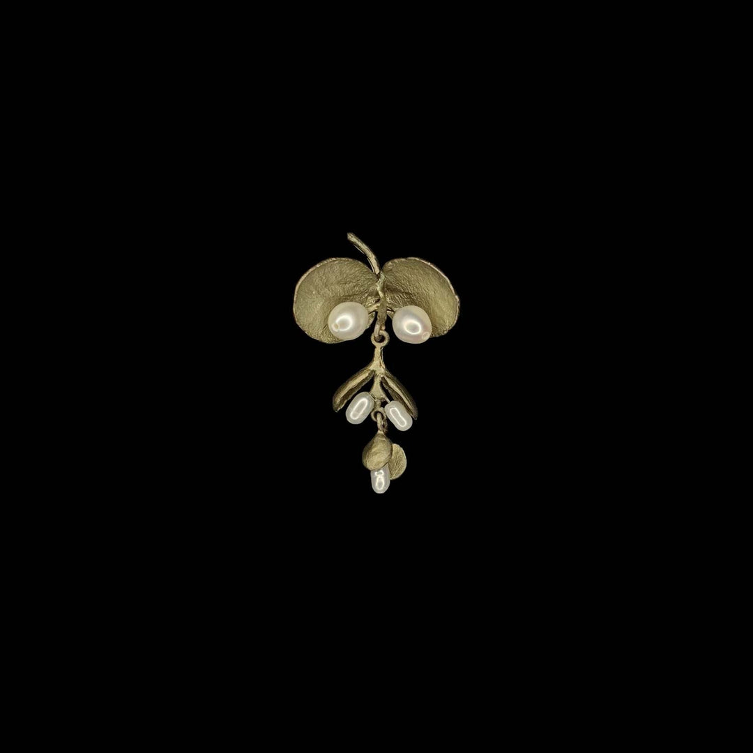 Image of the Michael Michaud Eucalyptus Seed Lapel Pin on a black background