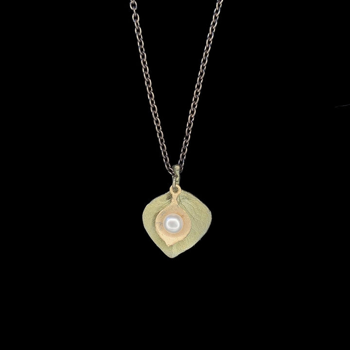 Image of the Michael Michaud Round Leaf Eucalyptus Pendant - Dainty on a black background