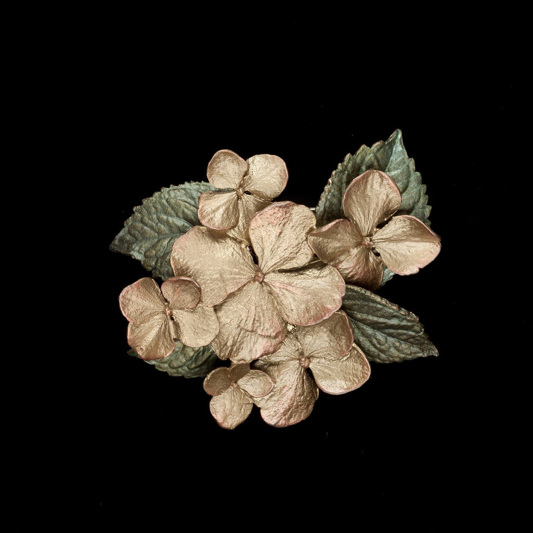 Image of the Michael Michaud Hydrangea Brooch on a black background