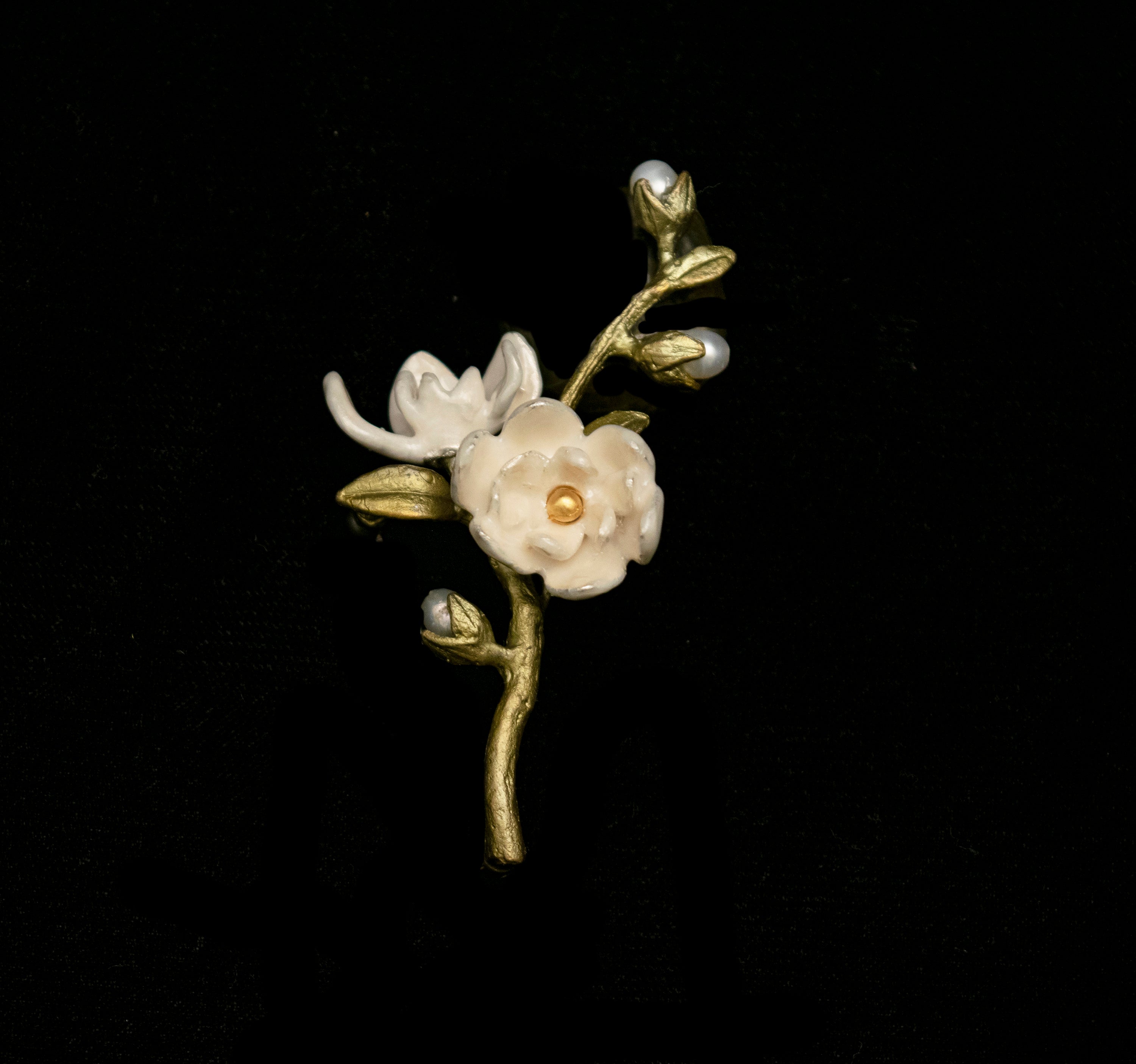Image of the Michael Michaud Magnolia Flower Brooch on a black background