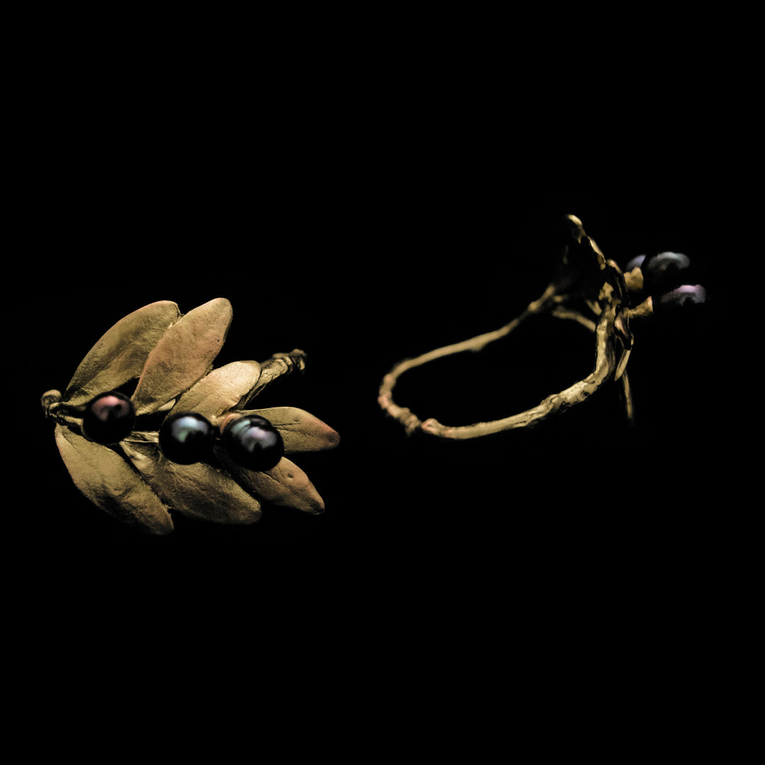 Image of the Michael Michaud Olive Napkin Rings on a black background