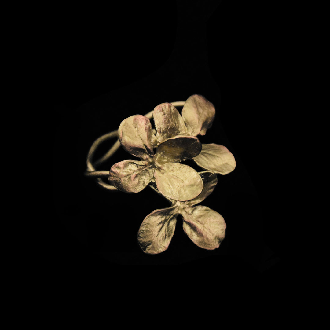 Image of the Michael Michaud Clover Napkin Rings - Bronze on a black background