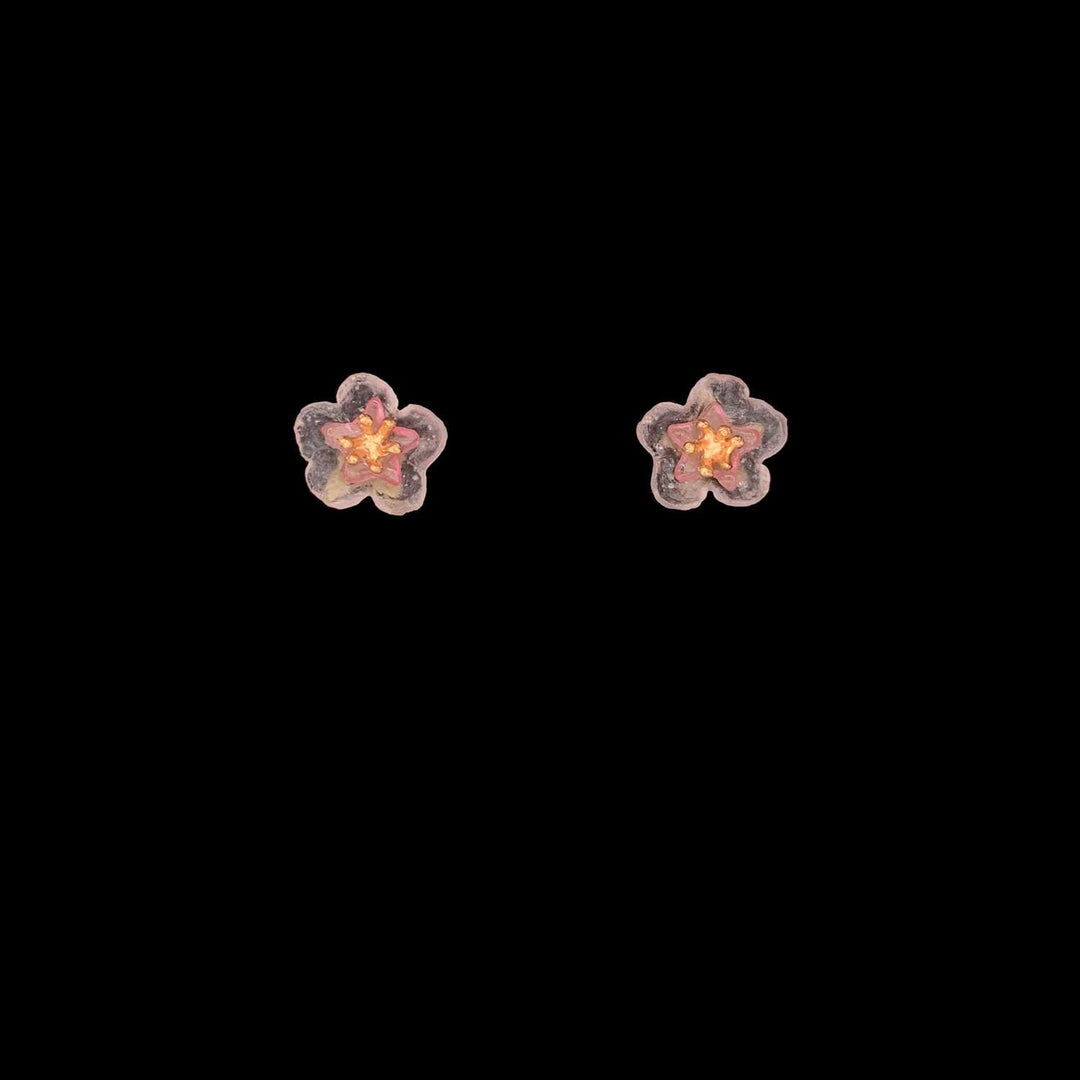 A pair of dainty peach blossom earrings with post-style closures, crafted from green patinated bronze with cast glass flowers and gold-plated centers.