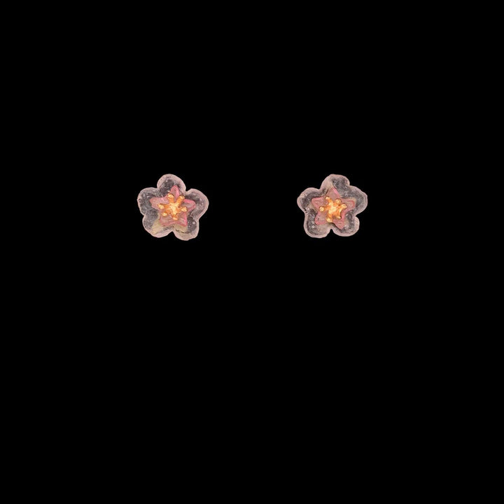 A pair of dainty peach blossom earrings with post-style closures, crafted from green patinated bronze with cast glass flowers and gold-plated centers.