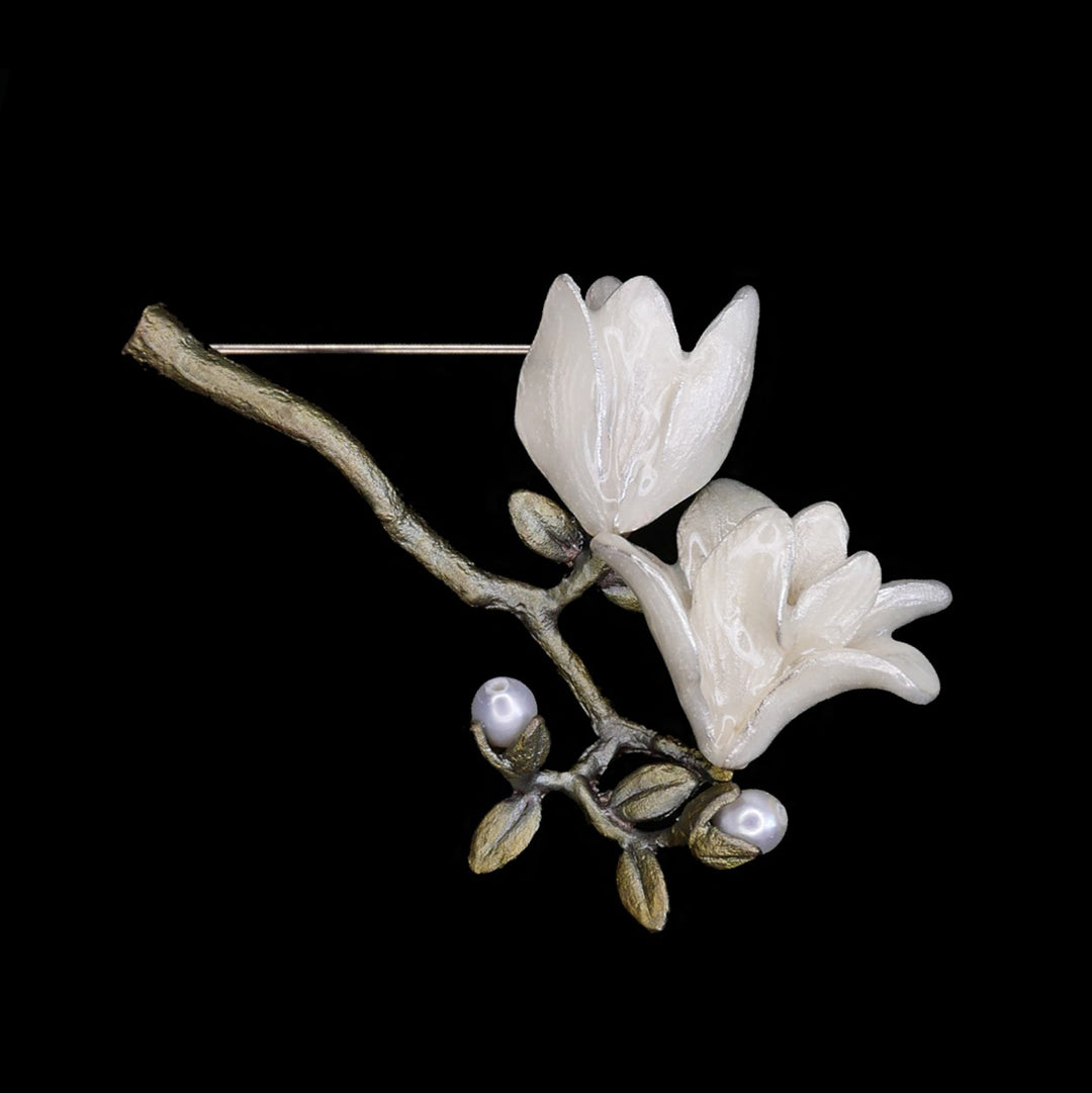 Image of the Michael Michaud Magnolia Blossom Brooch on a black background