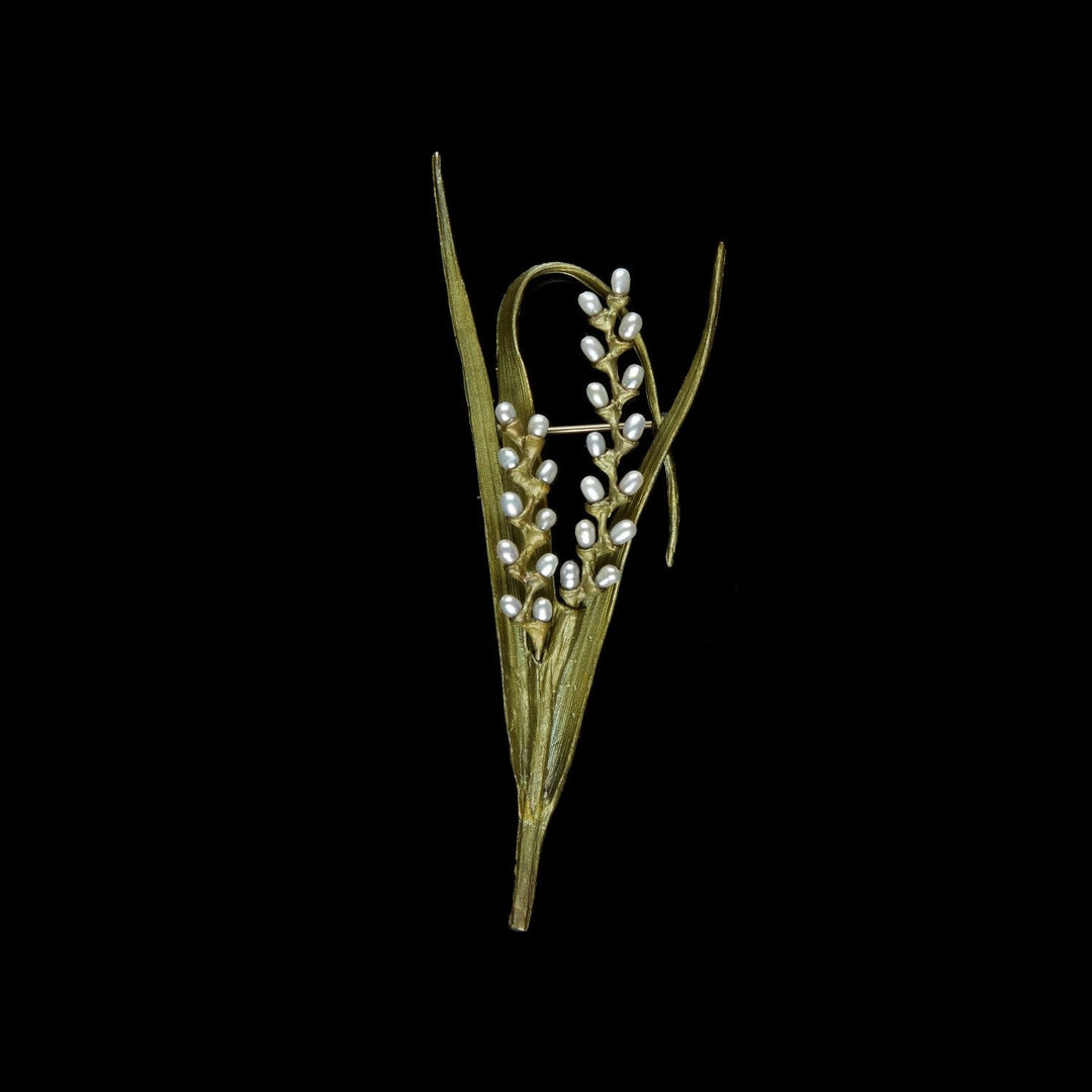 Image of the Michael Michaud Rice Brooch on a black background