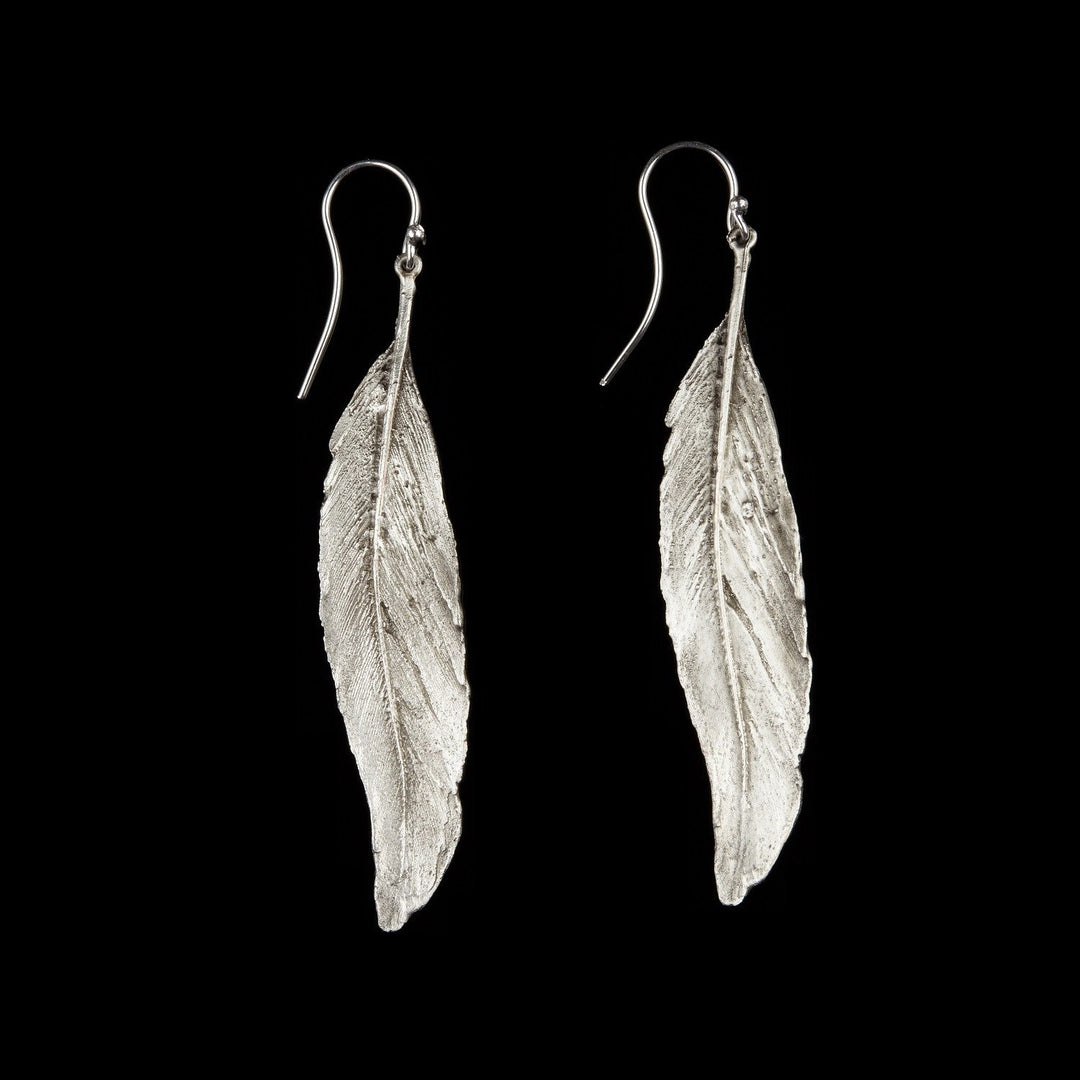 Image of the Michael Michaud Feather Earrings - Long Single Wire Silver on a black background