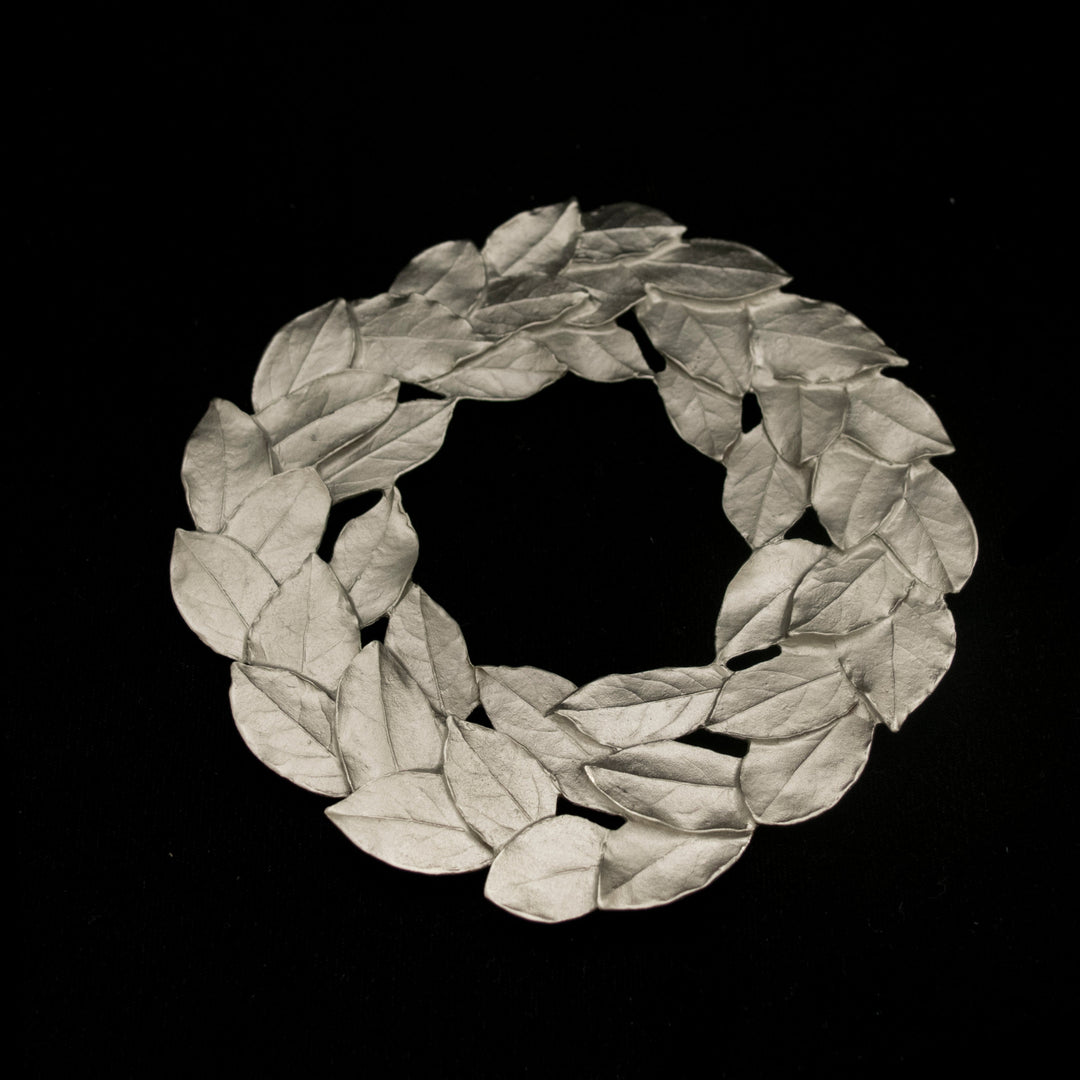 Image of the Michael Michaud Bay Leaf Trivet - Pewter on a black background