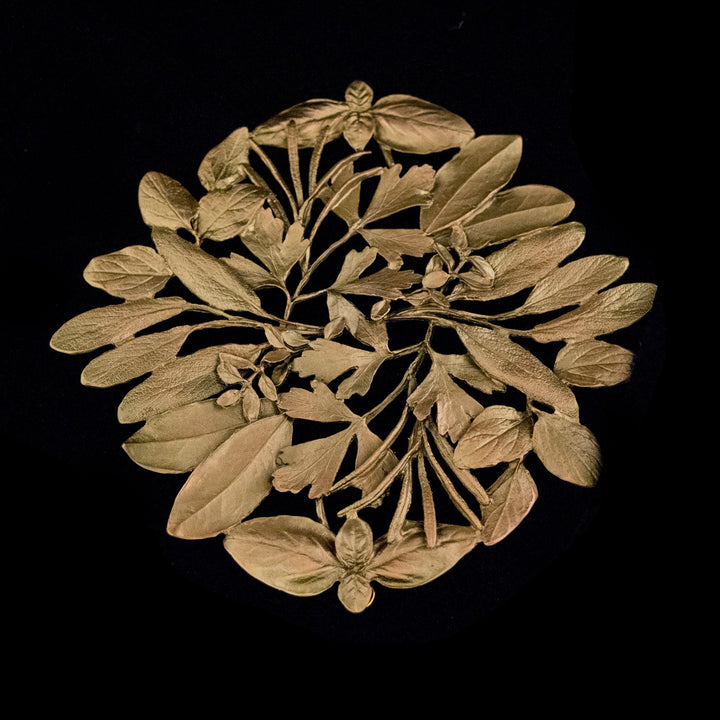Image of the Michael Michaud Herb Trivet - Bronze on a black background