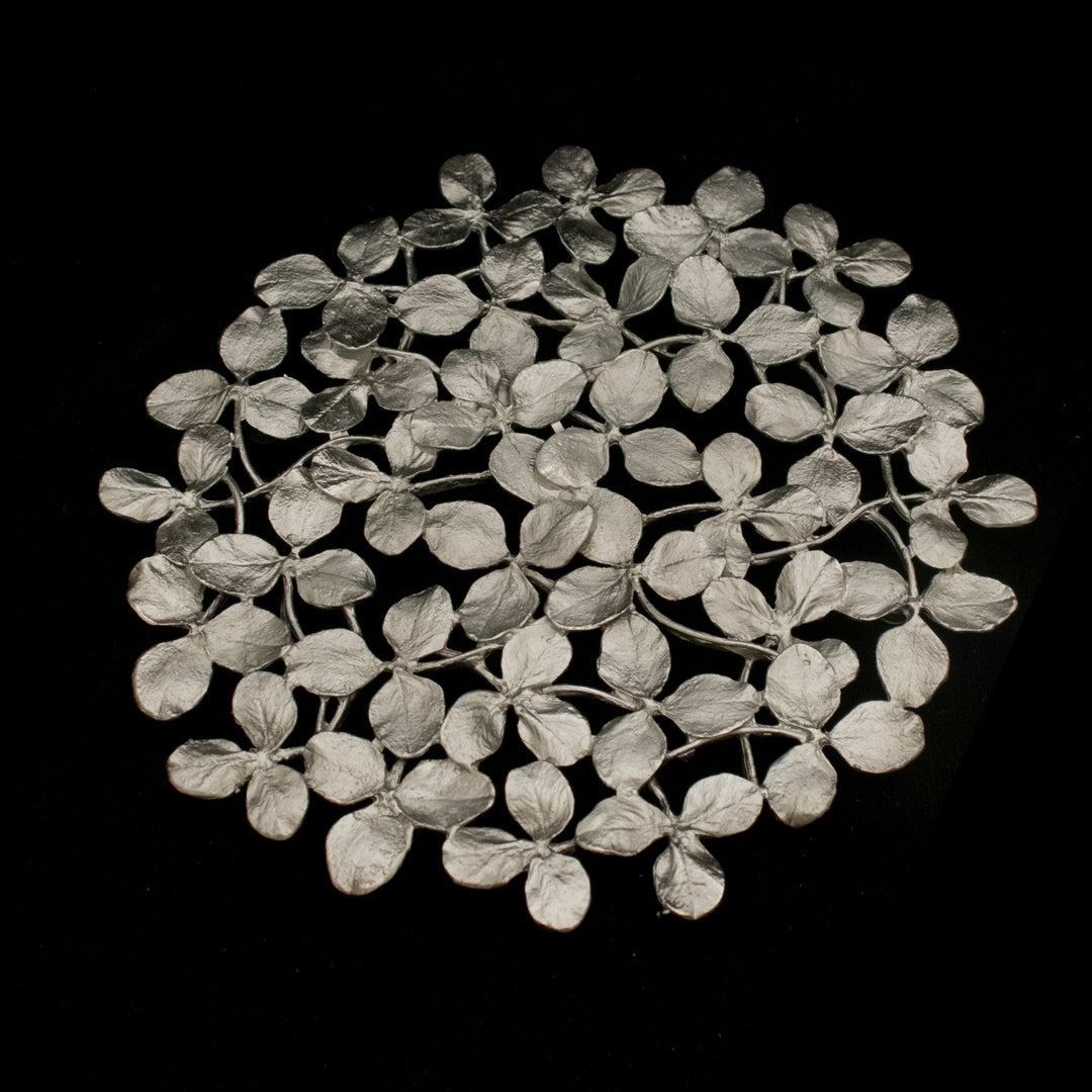 Image of the Michael Michaud Clover Trivet - Pewter on a black background
