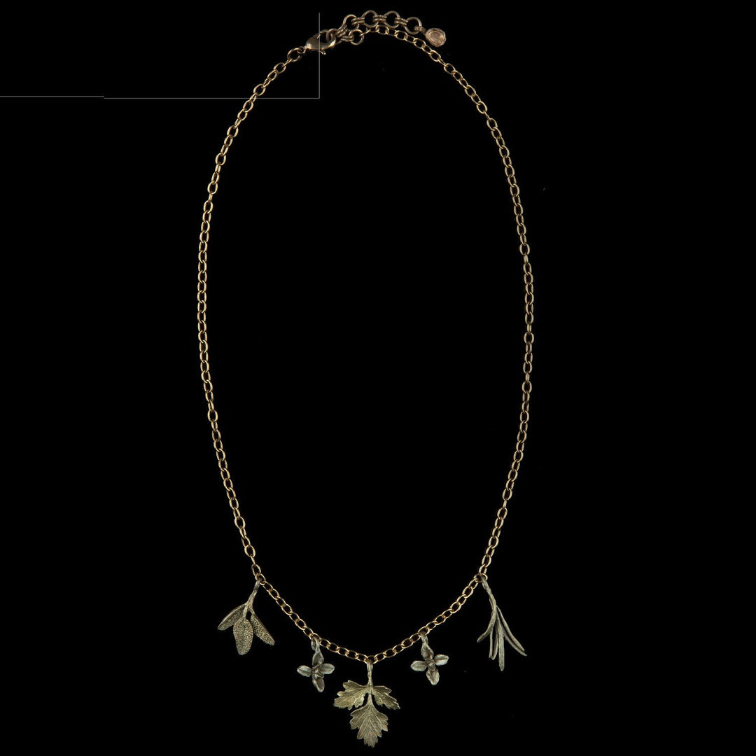 Image of the Michael Michaud Petite Herb Charm Necklace on a black background