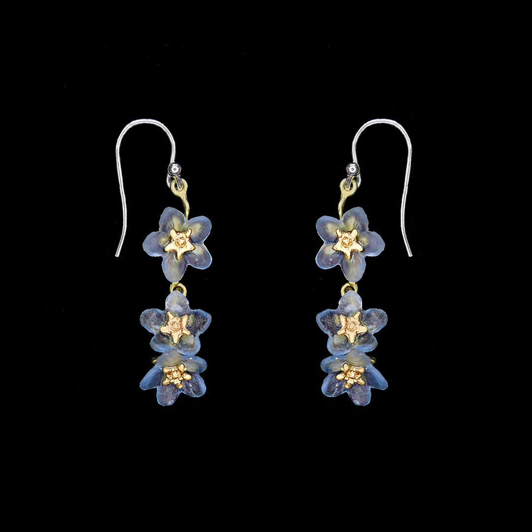 Image of the Michael Michaud Forget Me Not Earrings - Triple Flower Wire on a black background